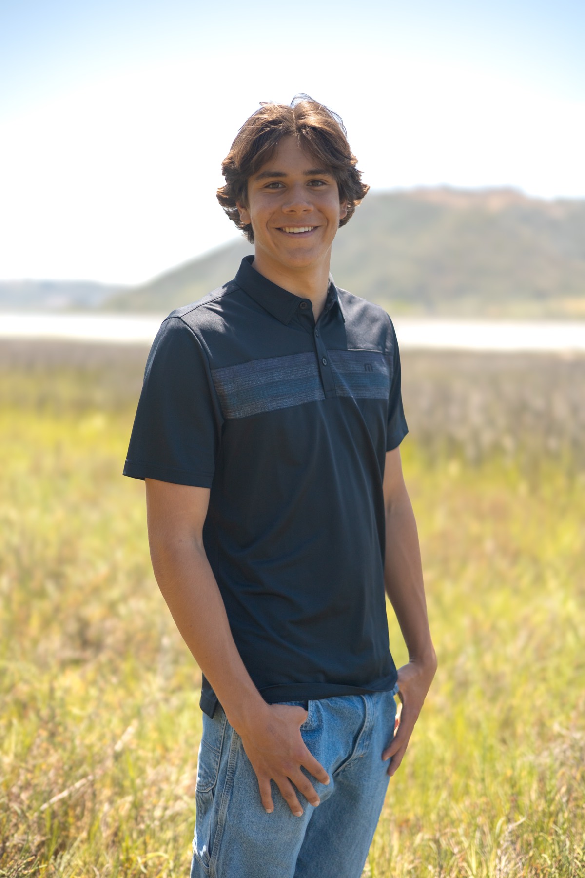 Senior portrait in a grassy field