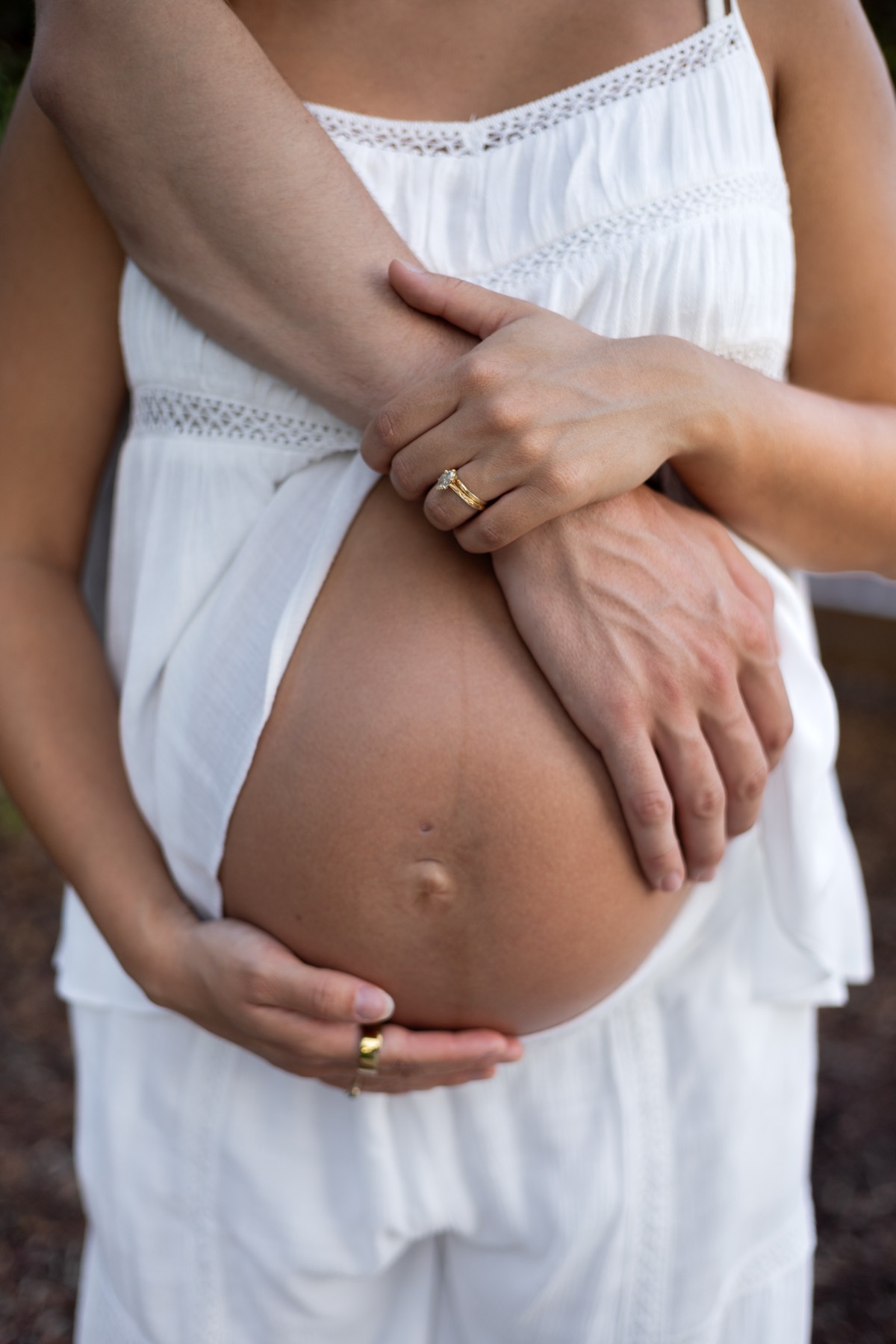Close-up of hands cradling a baby bump