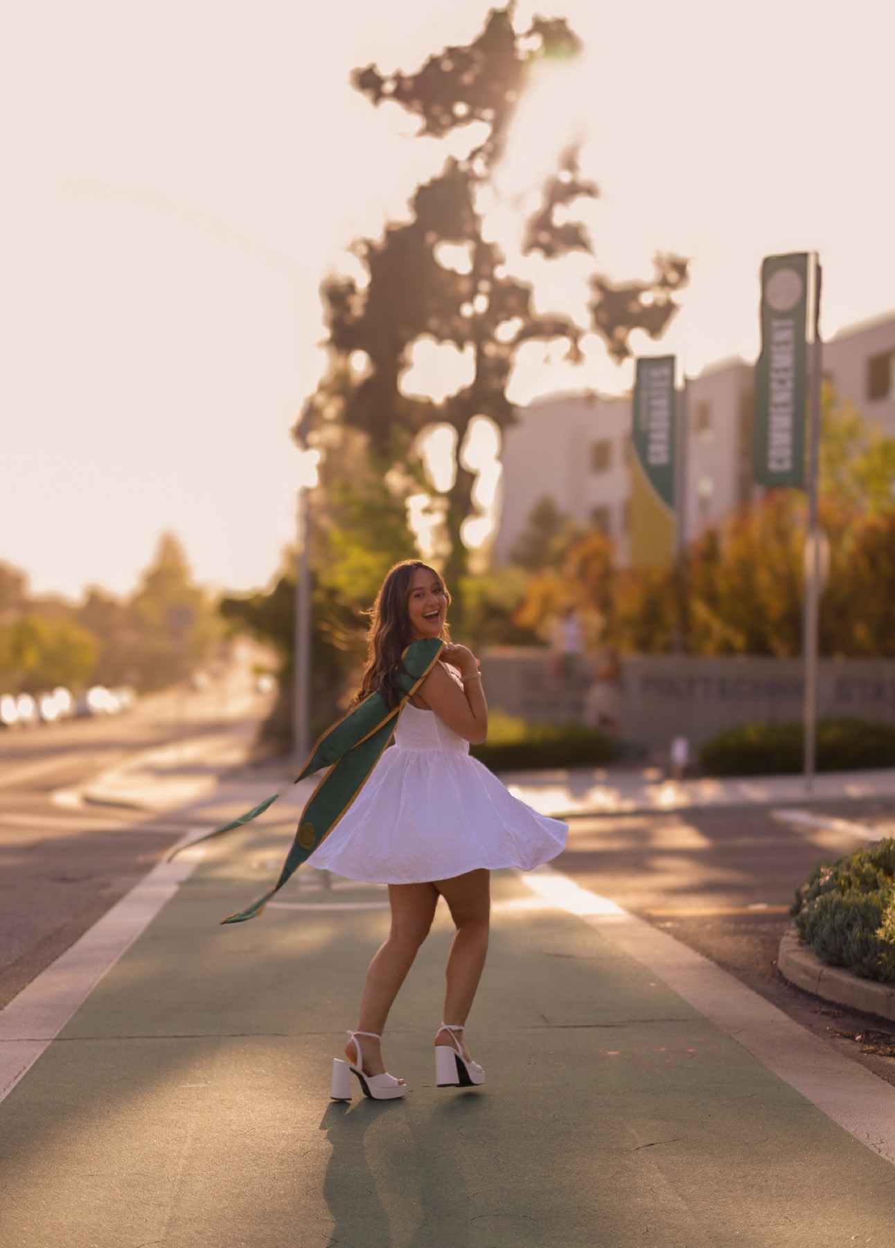 Graduate walking under palm trees
