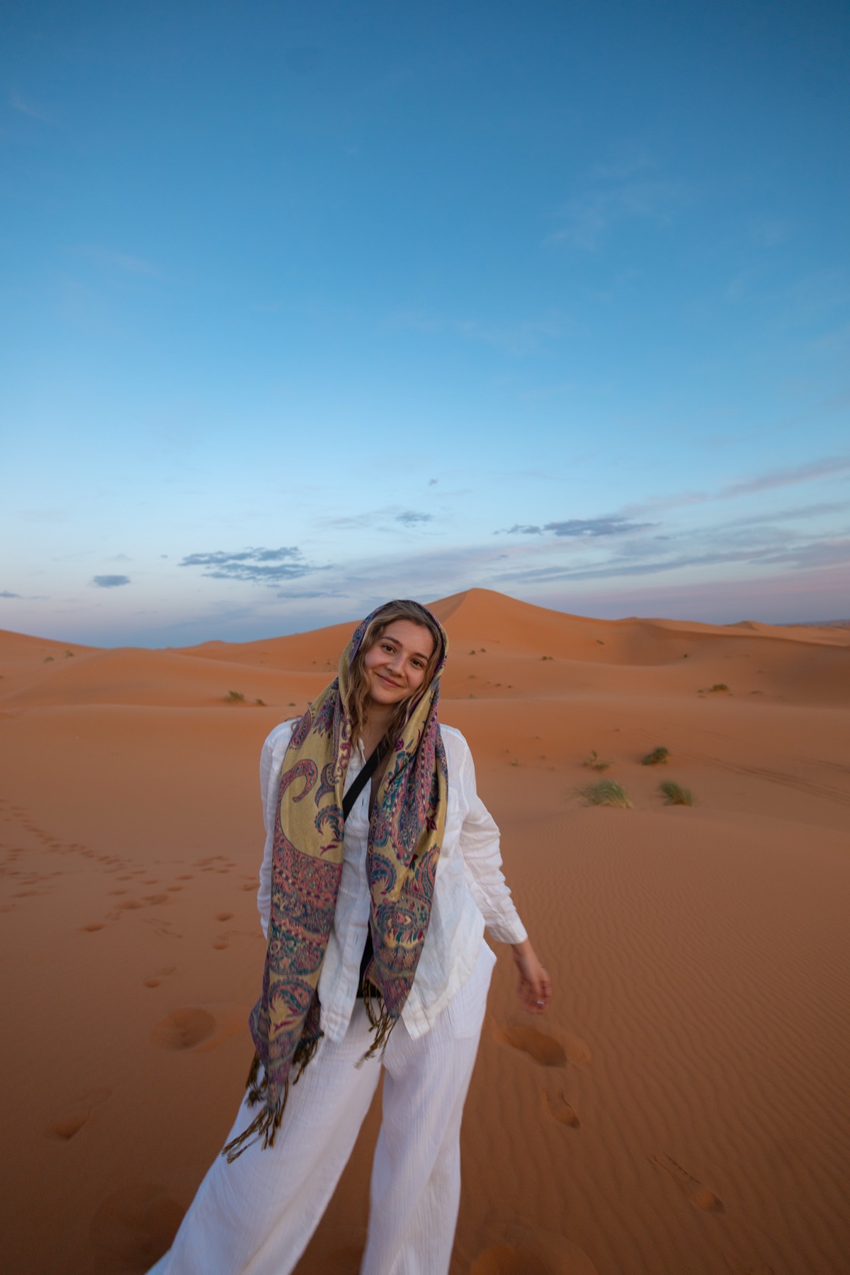 Olivia Hernandez smiling on the sand dunes while studying abroad